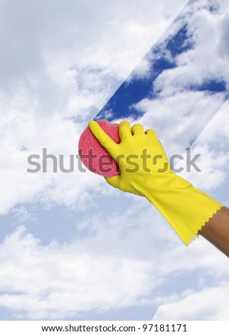hand in glove cleaning window with sponge, cleaning window