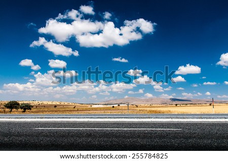 Long desert highway under the hot sun.