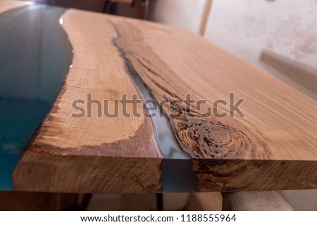 Epoxy resin in cracked walnut massif. Artistic processing of wood. furniture loft. modern furnishings. table-tops