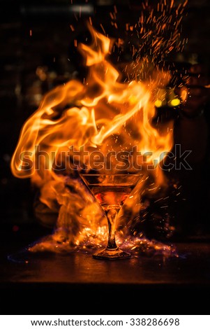 The bartender makes a cocktail of fire.