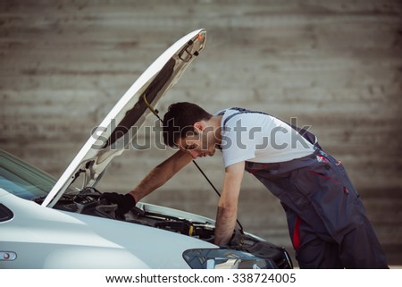 Car service: mechanic looks for errors in the car, car repairs, warranty