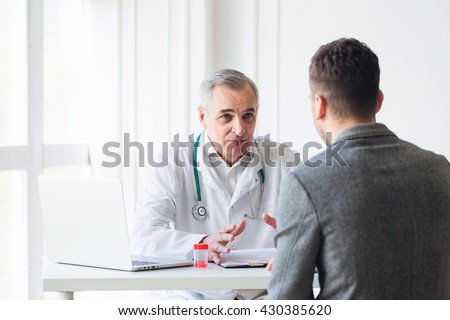 Senior doctor consults young patient