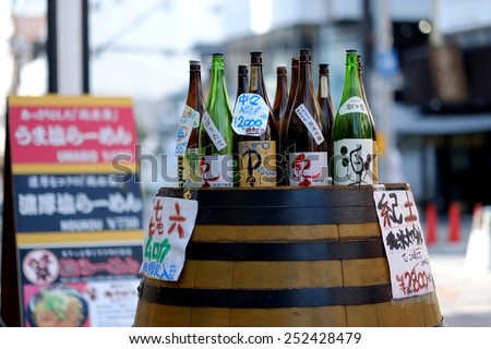 NARA ,JAPAN - DECEMBER 30 , 2014 : Japan Sake in Nara. A Japan Sake shop set bottles on a barrel for a promotion to tourist on Shopping zone in nara,japan