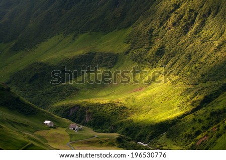 Bird\'s eye view into green valley in Swiss Alps in Europe.