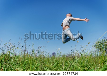 Happy young man jump on field