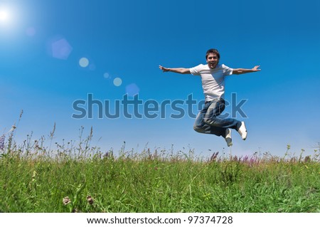 happy young man jump on field