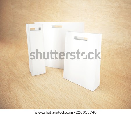 Set of white paper bag on wooden background.