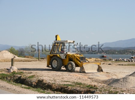 one yellow digger works outside