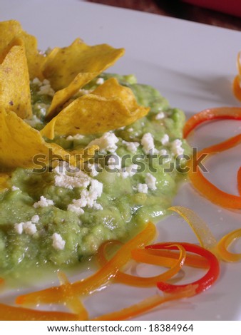 Mexican guacamole with nachos, in a mexican restaurant.