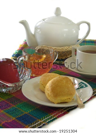 English breakfast with tea, scones, jelly and marmalade on white background