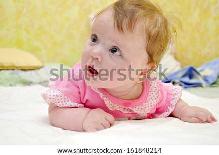 small chest girl lying on her stomach and looking surprised