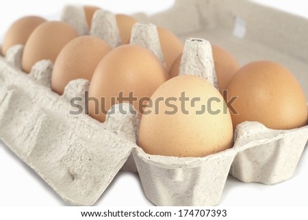 Eggs isolated on a white background in a carton.