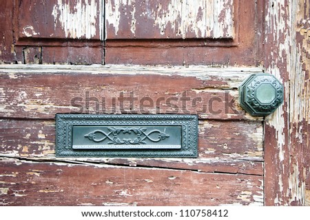 Ancient front door with metal post box