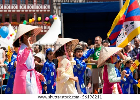 FRANKFURT - JUNE 26. Three young chinese girls cheering at the Parade der Kulturen. June 26, 2010 in Frankfurt, Germany.