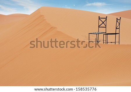 black steel chairs setting on the top of sand dune, Sahara desert, Morocco