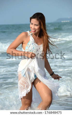 Long hairs beautiful lady walk on the beach and wind blow her hairs