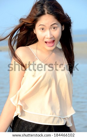 Long hairs beautiful lady walk on the beach and wind blow her hairs.