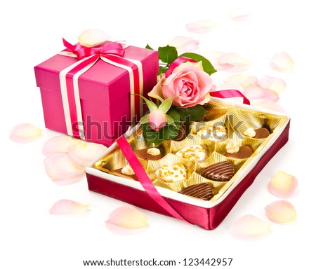 Box of chocolate pralines, rose and a pink gift box for Valentine