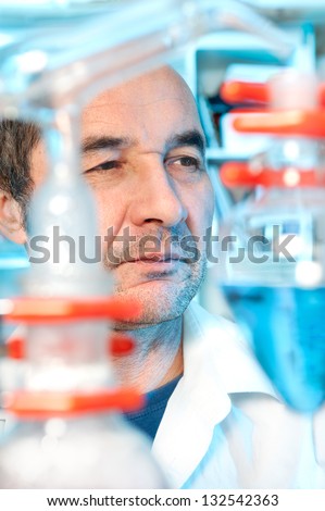 Senior tech works in chemical laboratory