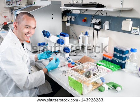 Smiling young scientist works in the lab