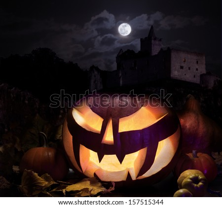 Halloween pumpkin with haunted castle under moonlight