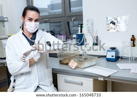 Young student or tech with laboratory mouse