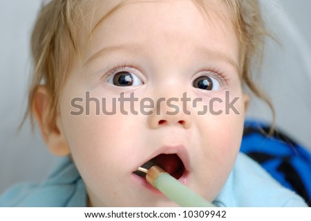 baby with a toy in his mouth to ease teething