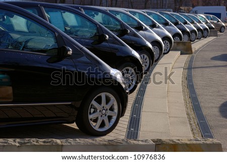 stock photo row of twelve grey and black cars displayed for sale