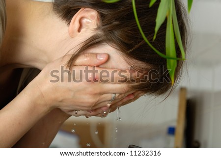 thirty six year old woman with damaged hand washes her face