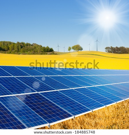 Solar power cells, rapeseed field and windmills on the horizon