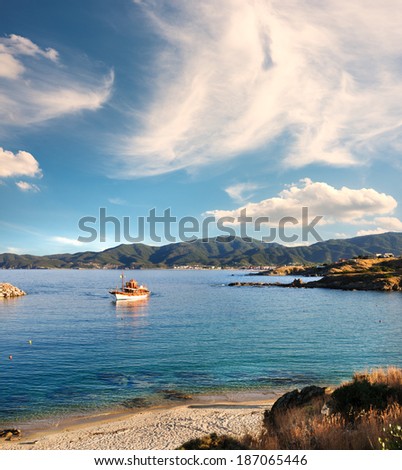 Fisherman boat approaches the shore late in the day. Sithonia, Northern Greece