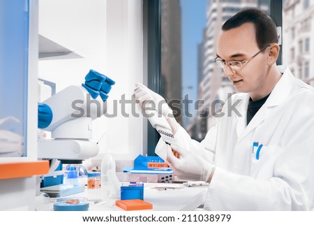 Young male scientist works in the lab, toned image
