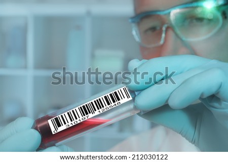 Tech with a medical sample labeled with a barcode