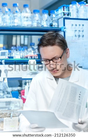Young scientist or tech works in modern laboratory