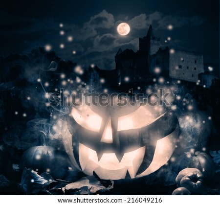 Halloween pumpkin with haunted castle under moonlight