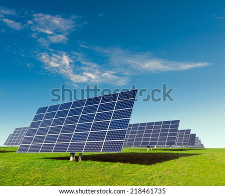 Solar panels on a field under blue sky