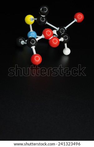 Model of chemical molecule on black background, text space