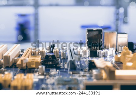 Detail of electronic board in hardware repair shop, blurred and toned image, space for your text