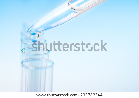 Scientific background: drop from pipette falling in a tube, text space