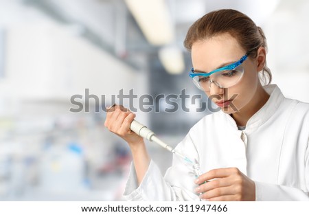 Young female tech or scientist loads sample with automatic pipette