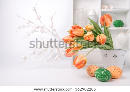 Easter greeting card design with bunch of tulips and painted eggs on abstract white background