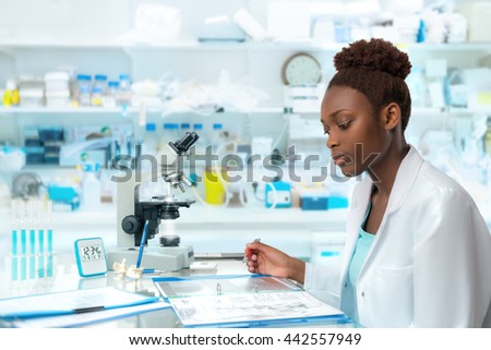 African scientist, medical worker, tech or graduate student works in modern biological laboratory