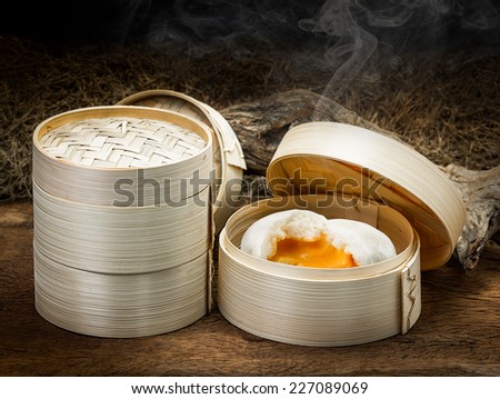 Chinese steamed bun and sweet creamy stuff in bamboo ware