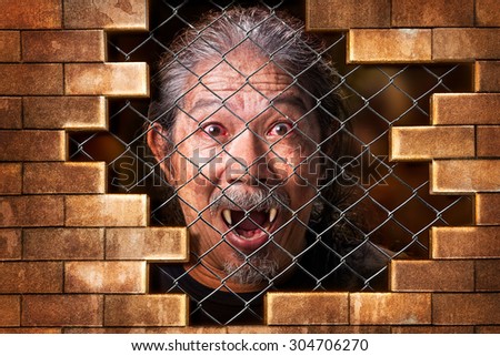 Imprison old man vampire internal the metal grate bar and brick wall in concept of detain the wicked evil