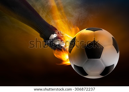 Strength of athlete to kicking the soccer ball with power fire blaze in dark background