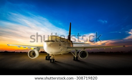 Parking business airplane at the airport runway in the beautiful sunset background