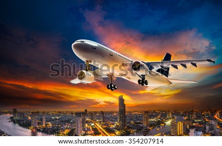Airplane for transportation flying over the night scene city on beautiful sunset background
