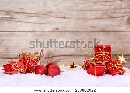 Presents and apples in the snow, space for text