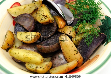 Purple and yellow new potatoes roasted in olive oil and spices including Dill weed