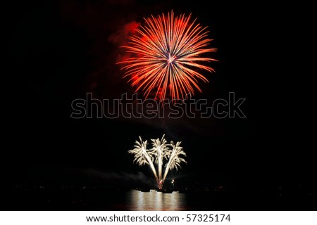 Colorful nighttime fireworks against a solid black sky over Lake Tahoe on the fourth of July holiday 2010